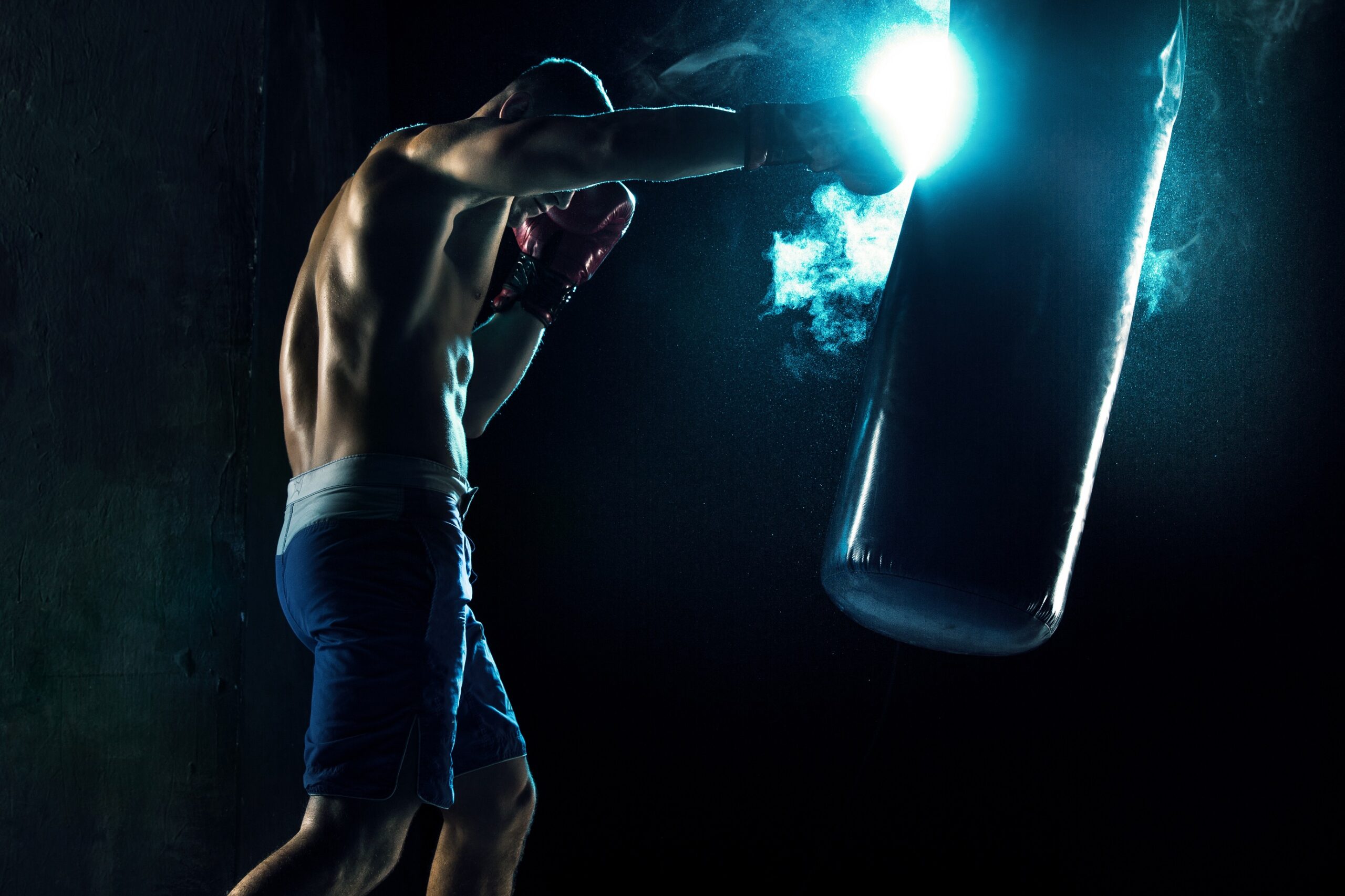 Male,boxer,boxing,in,punching,bag